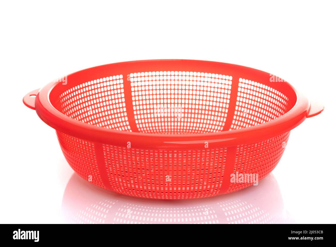 plastic sieve of red color on a white isolated background Stock Photo