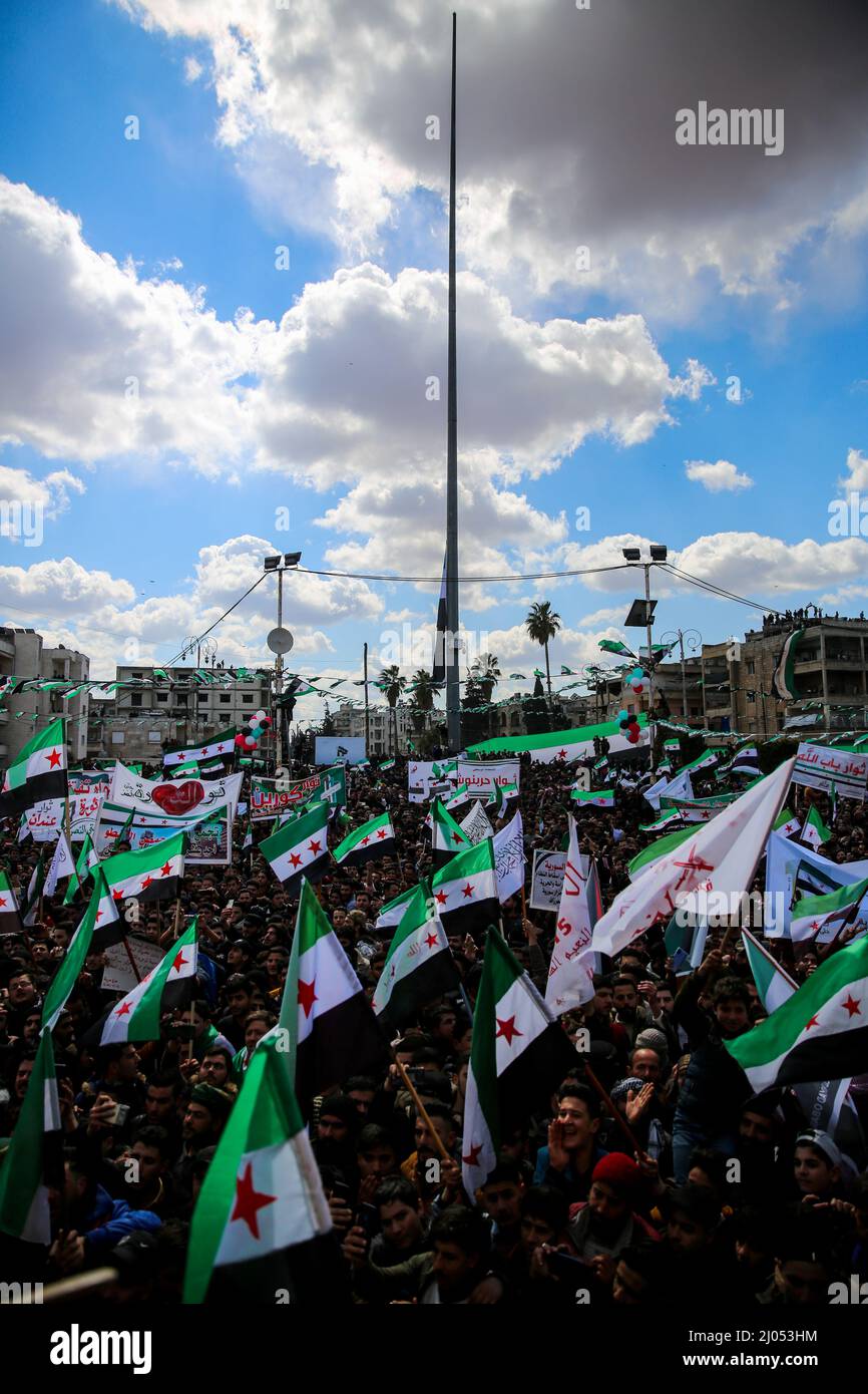 March 15, 2022, Idlib, Idlib governorate, Syria: Idlib, Syria. 15 March 2022. Thousands of demonstrators gather in the Syrian northwestern city of Idlib to mark the 11th anniversary of the Syrian uprising. Many demonstrations were held in the north of the country with participants calling for 'the fall of the Syrian regime, the release of political prisoners from jail, and the return of the displaced''. Demonstrators also raised Ukrainian flags in solidarity with Ukrainians and against the ongoing Russian invasion in Ukraine (Credit Image: © Juma Mohammad/IMAGESLIVE via ZUMA Press Wire) Stock Photo
