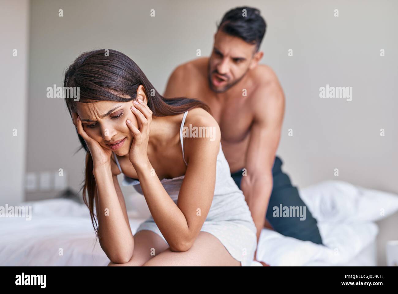 Woman attacking man in bed hi-res stock photography and images