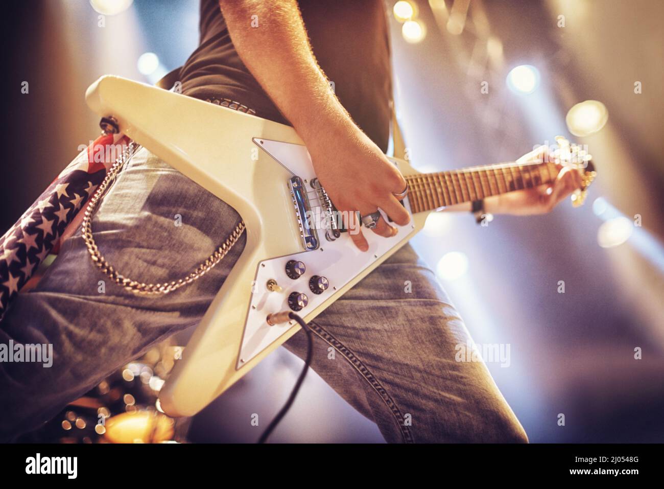 Low angle view of a guitarist on stage. This concert was created for ...