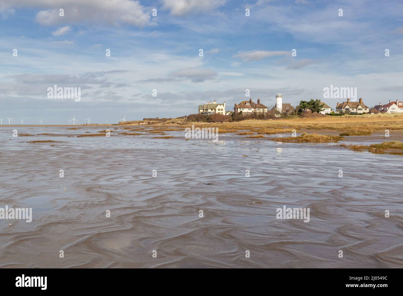 Hoylake, UK: Beach at Red Rocks reserve, and houses on Stanley Road on a sunny day, Wirral peninsula. Stock Photo