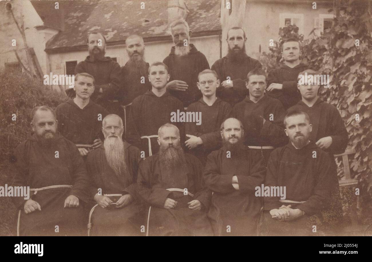 A group of  roman catholic Franciscan Monks are posing  very well for the camera in a  garden at 1890s. Source: original photograph. Stock Photo
