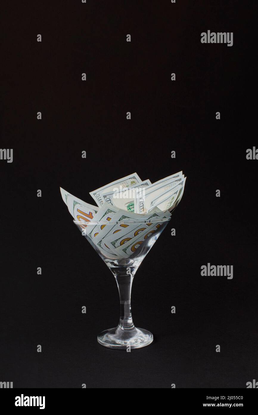 Dollar in Martini Glass. Glass is full hundred dollar bills Stock Photo Alamy