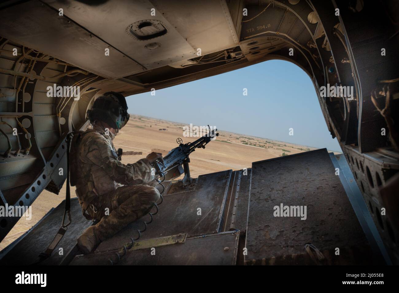 Rear gunner on a flight on a British military Chinook helicopter of Helmand, Afghanistan Stock Photo