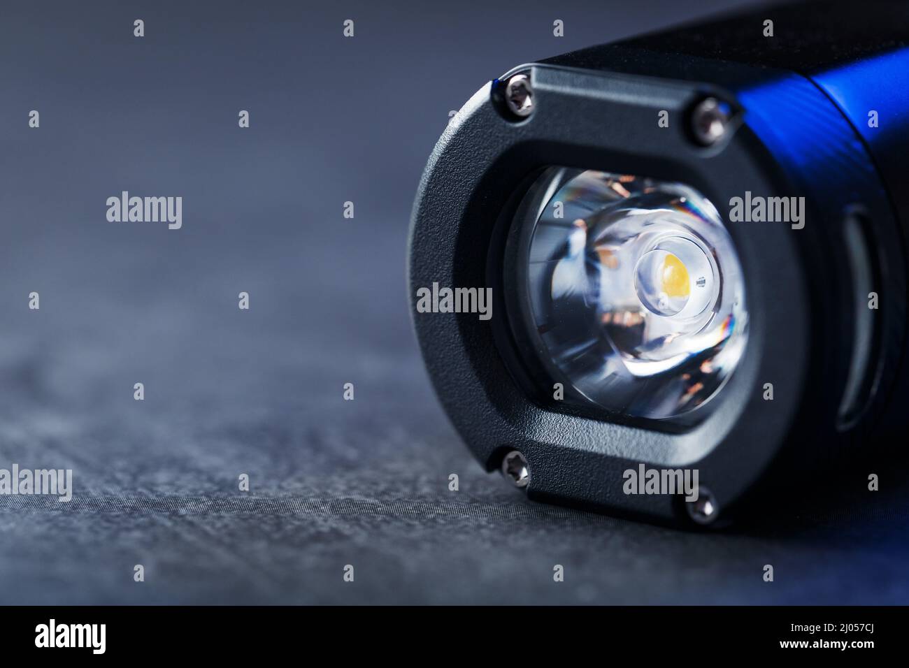 Black Rechargeable Flashlight handheld, LED close-up on a black background Stock Photo