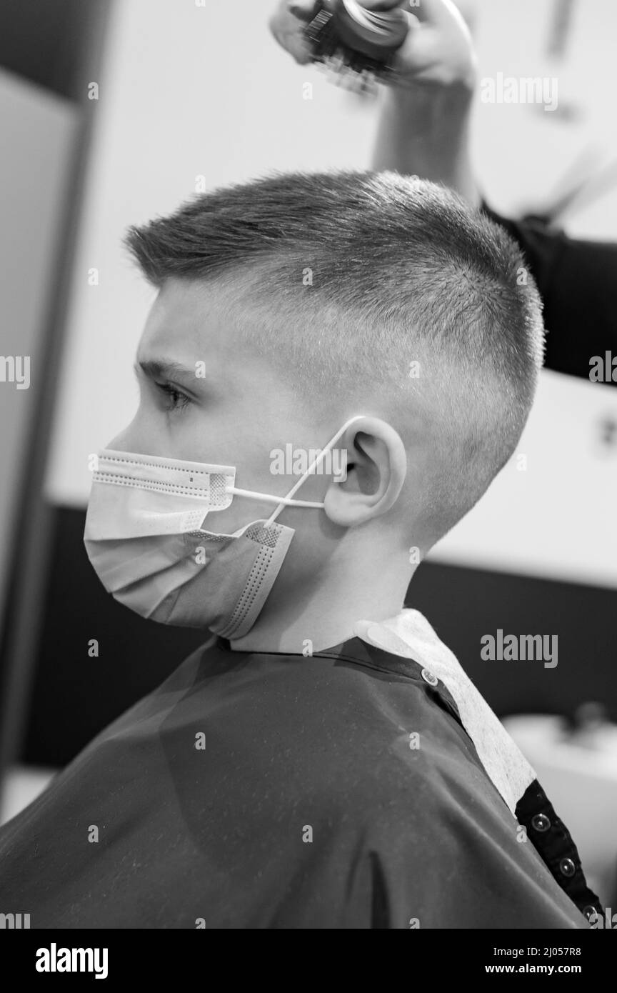 Schoolboy in a during a pandemic, stylish haircut for baby