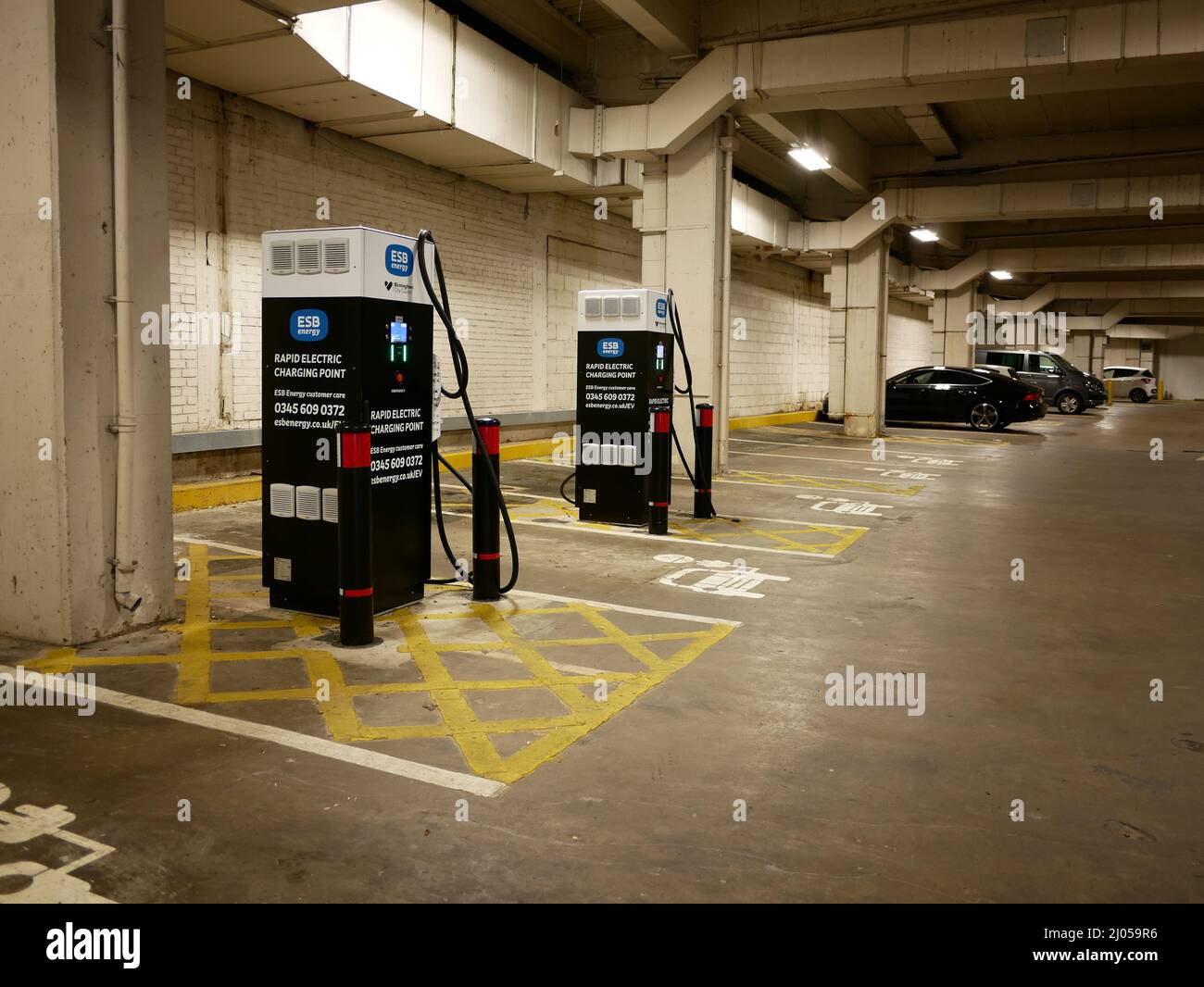 Electric car charging points in a city car park Stock Photo