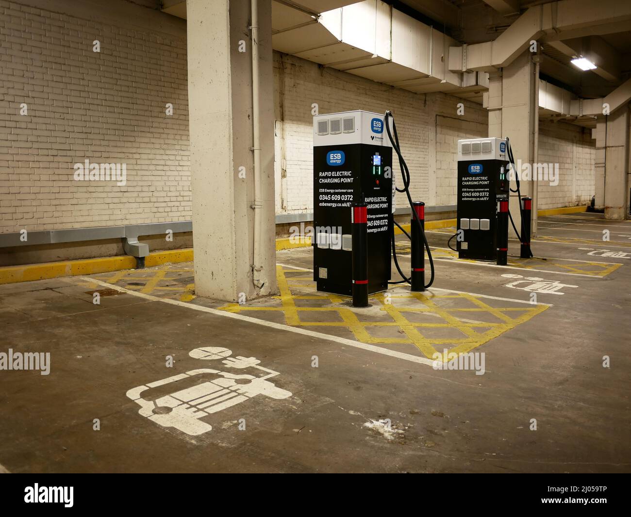Electric car charging points in a city car park Stock Photo Alamy