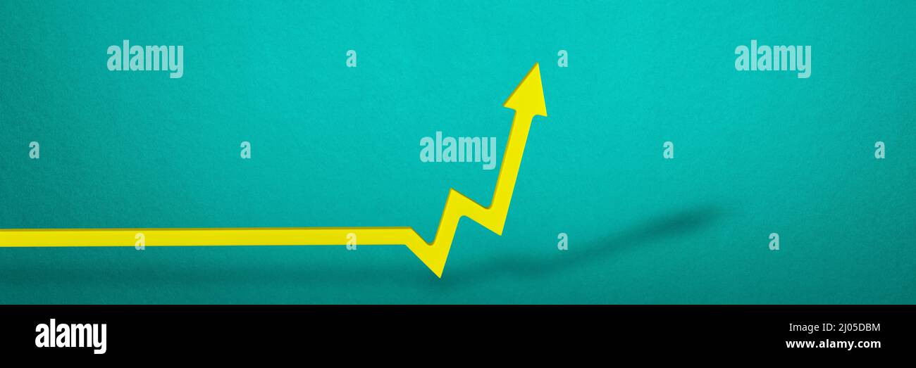 Inflation. Rising inflation. Global financial crisis. Yellow arrow on the graph indicating price growth, blue background. Stock Photo