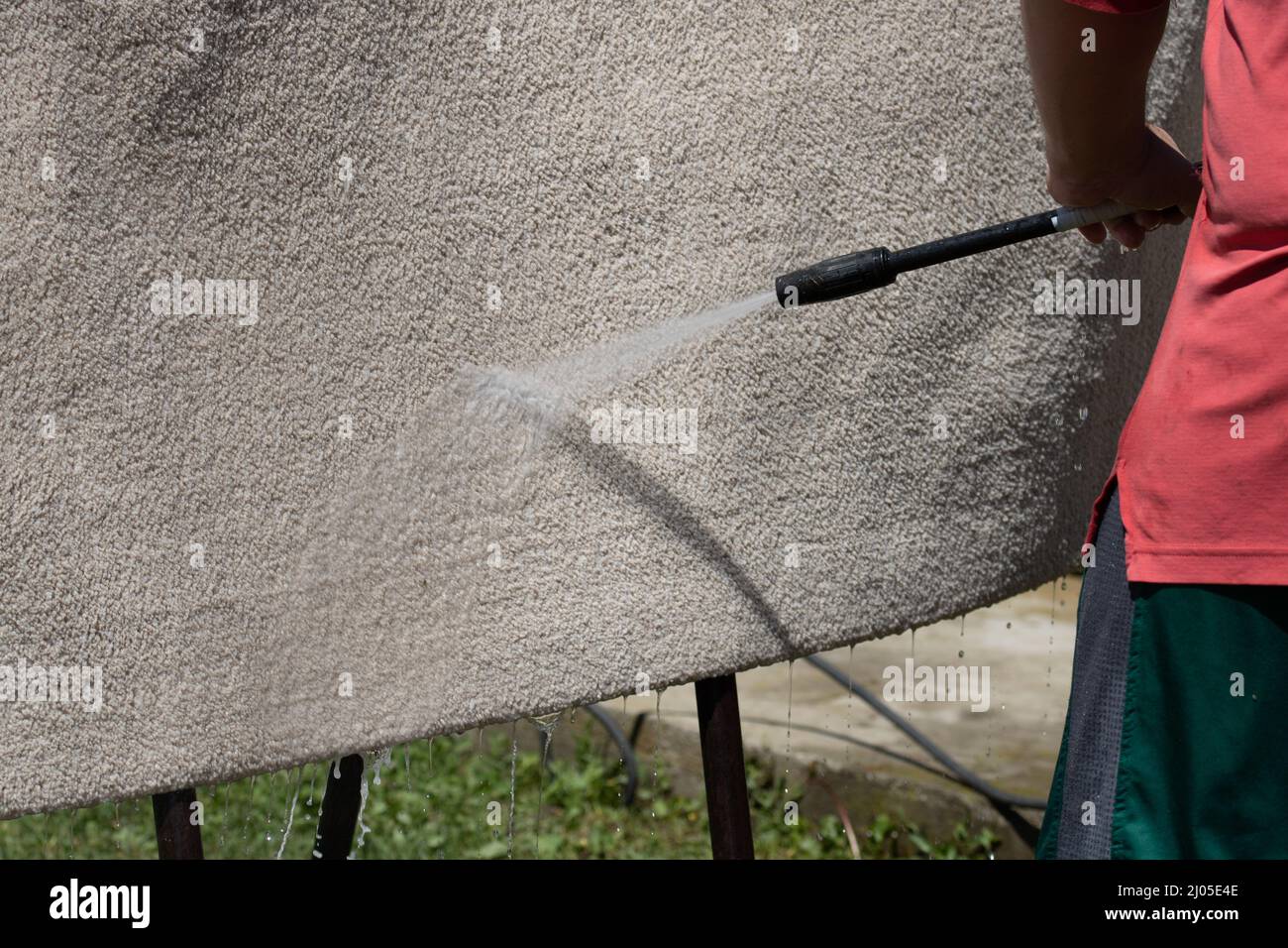 Washing carpets with high pressure washer. Cleaning the carpet with a