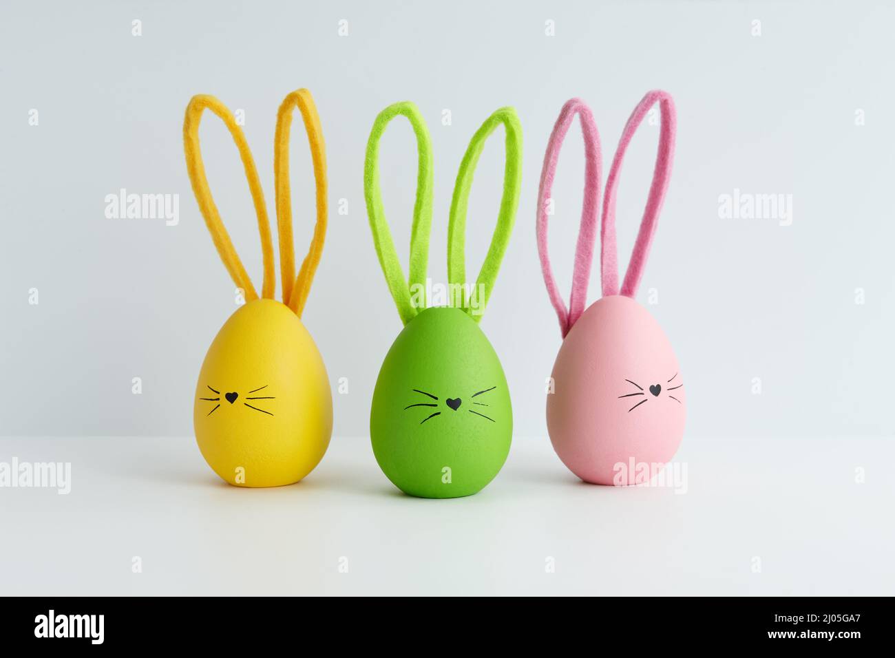 Colorful Easter eggs with bunny faces, holiday decoration Stock Photo