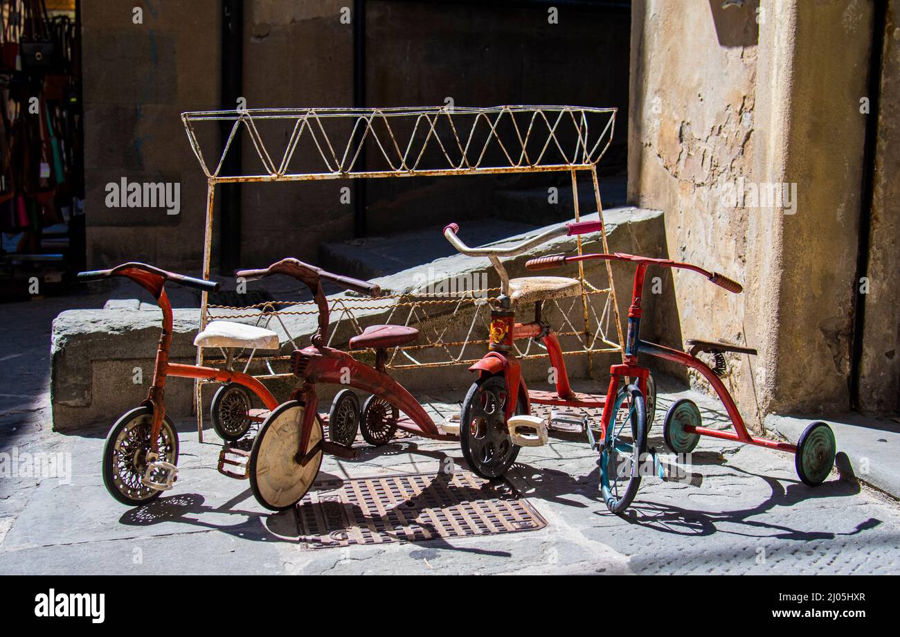 3 wheeler children's bicycle, three wheeled bike in a storefront in Rome, Italy. Stock Photo