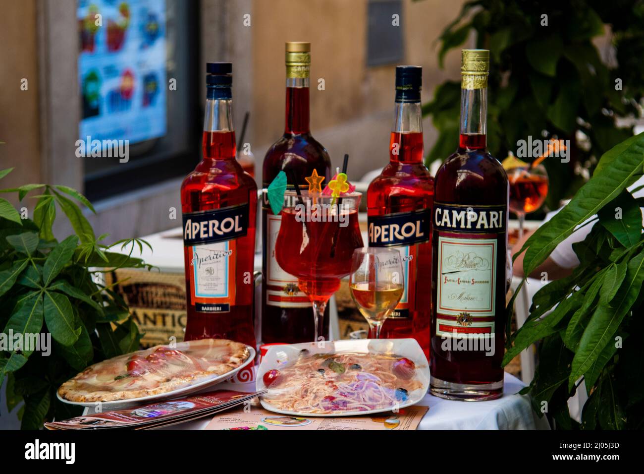 Aperol, Camperi and pizza's at a restaurant in Rome, Italy. Stock Photo