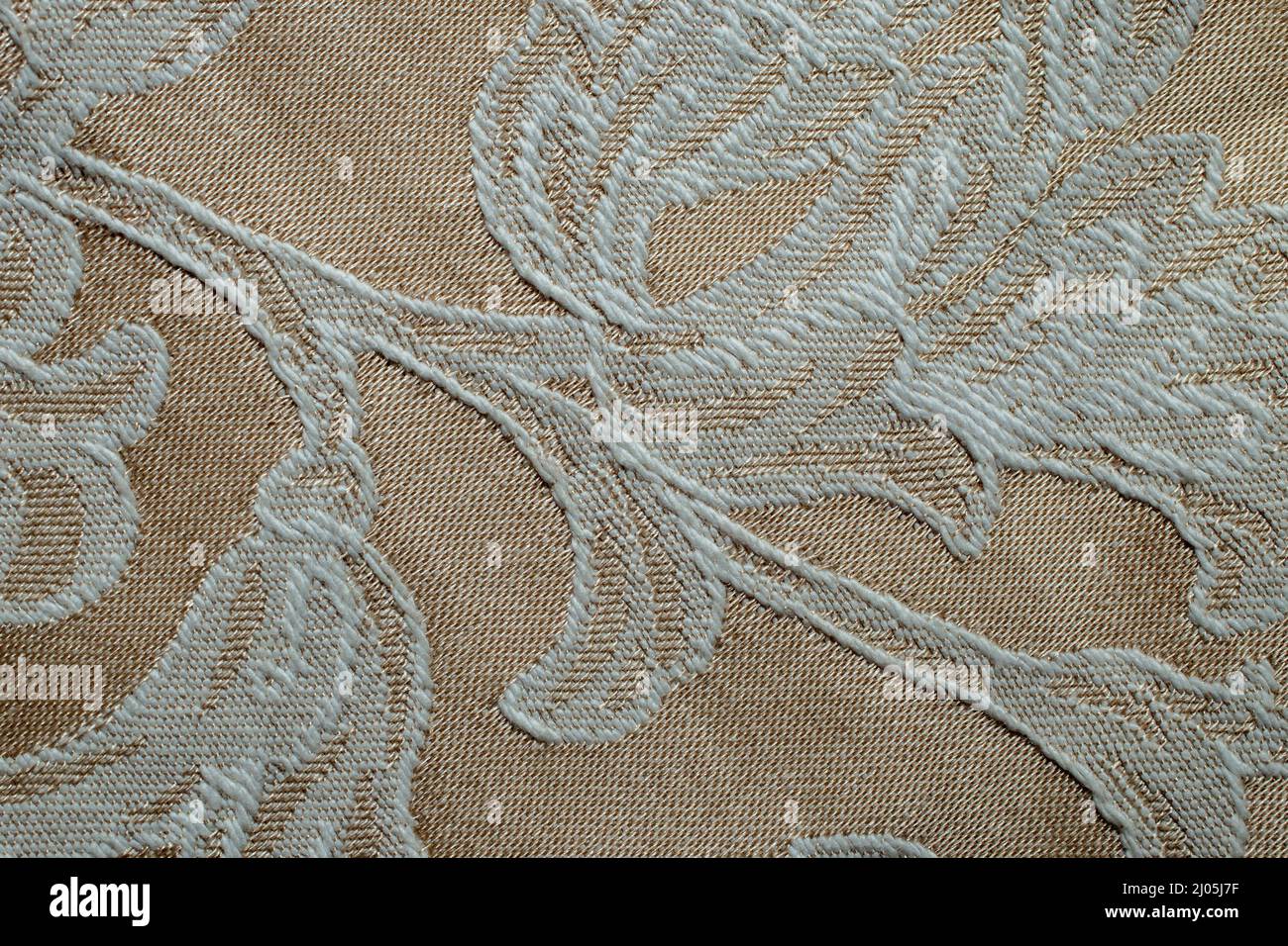 embroidery on a beige synthetic fabric, machine made Stock Photo