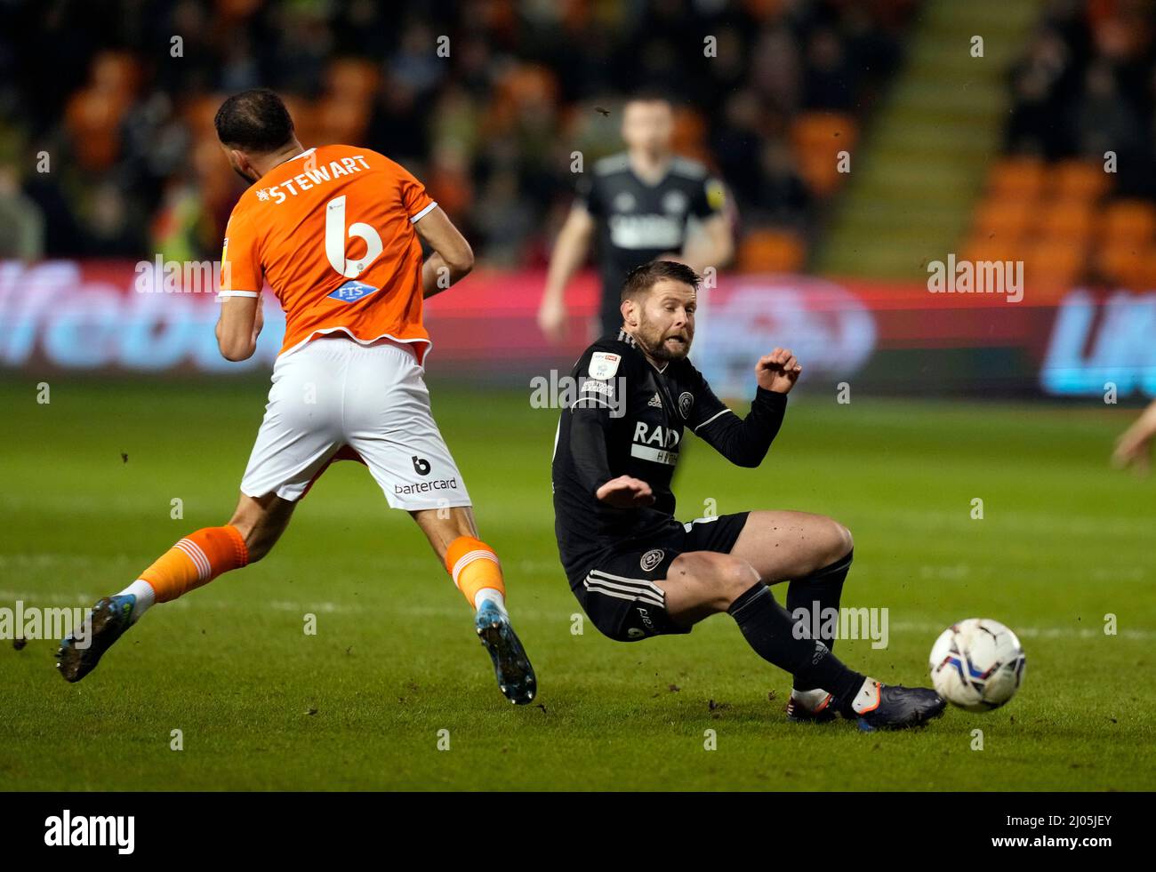 Blackpool, England, 16th March 2022.  Kevin Stewart of Blackpool tackled by Oliver Norwood of Sheffield Utd  during the Sky Bet Championship match at Bloomfield Road, Blackpool. Picture credit should read: Andrew Yates / Sportimage Credit: Sportimage/Alamy Live News Stock Photo
