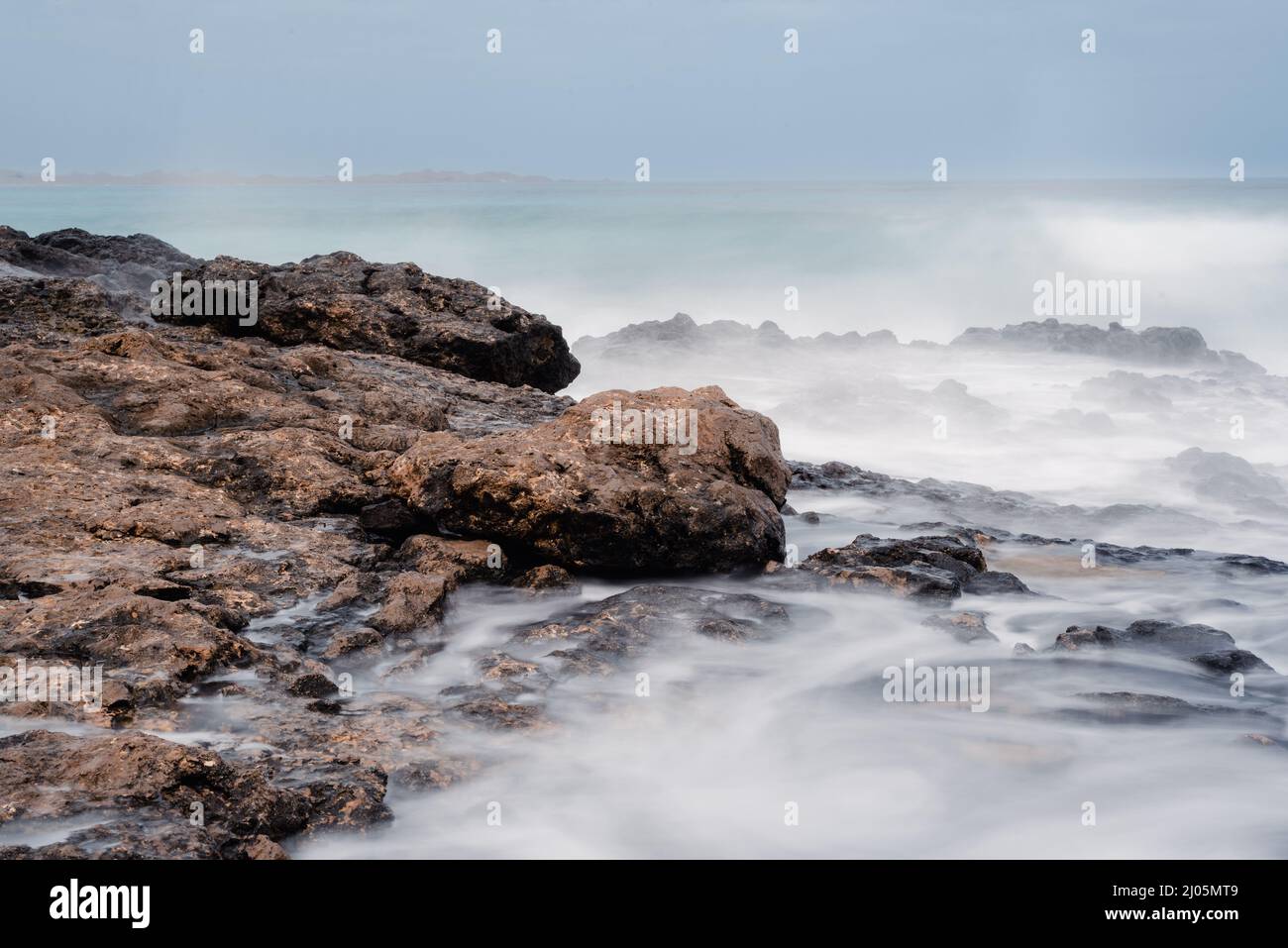 Waves break on the rock. Stock Photo
