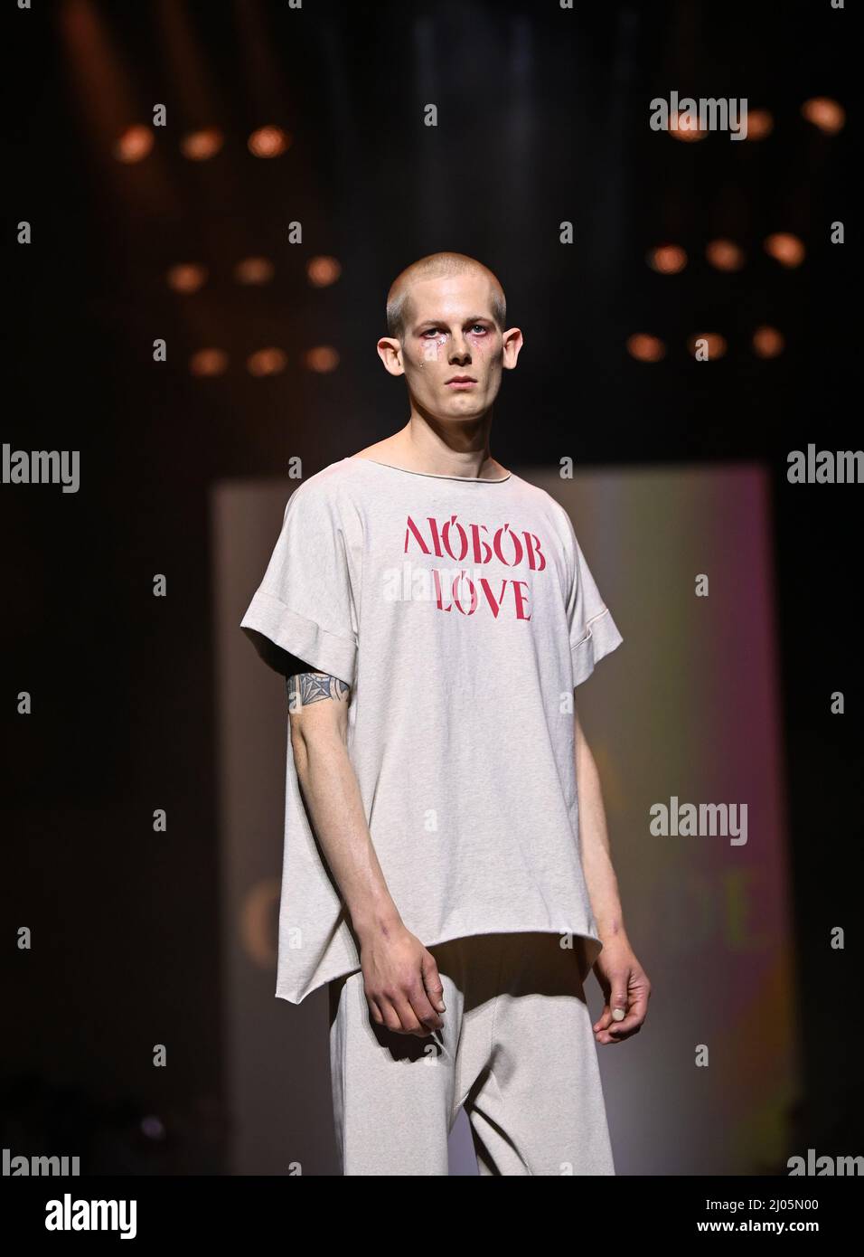 Berlin, Germany. 16th Mar, 2022. Berlin Fashion Week: At Kraftwerk Berlin,  a model presents a creation by Ukrainian designer Jean Gritsfeldt. Because  he cannot come to Berlin and the collection cannot be