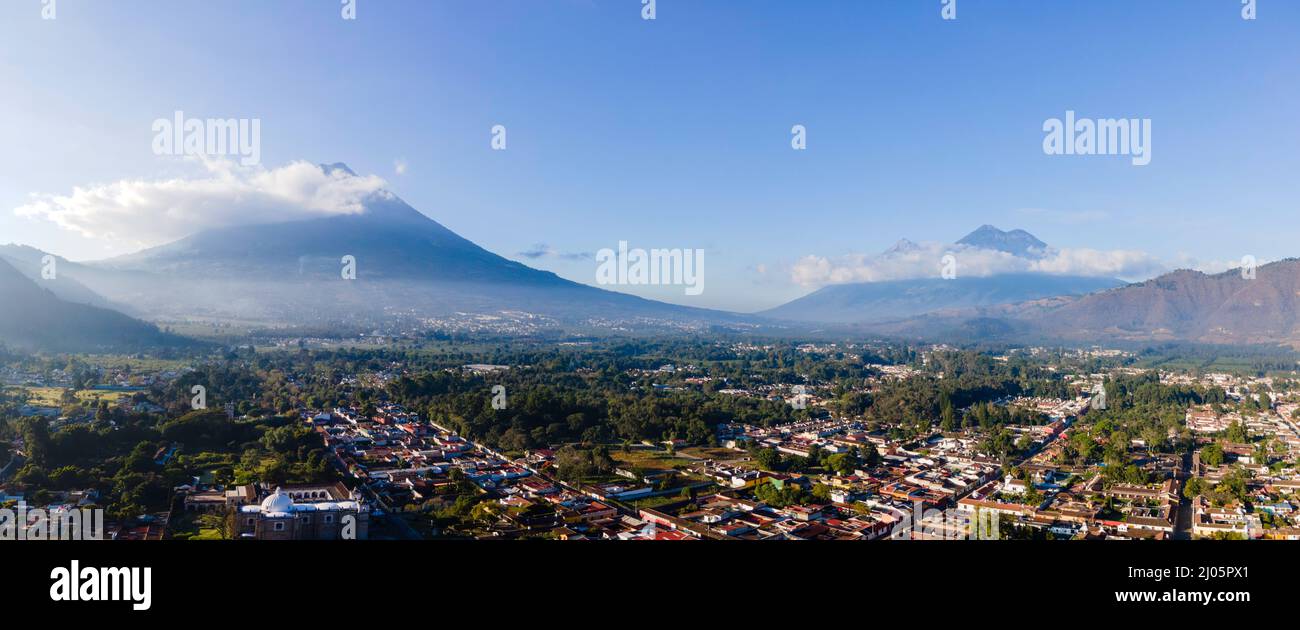Panoramic aerial photograph of Antigua, Guatemala on a beautiful morning, with Volc‡n de Acatenango (right) and Volc‡n de Agua (left) in the distance. Stock Photo
