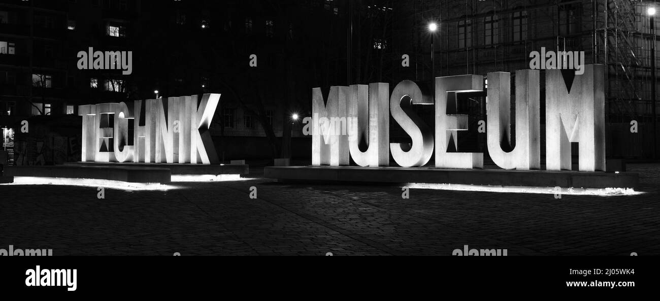 Berlin, Germany, January 19, 2022, nightly illuminated font installation in front of the Technik Museum in black and white. Stock Photo