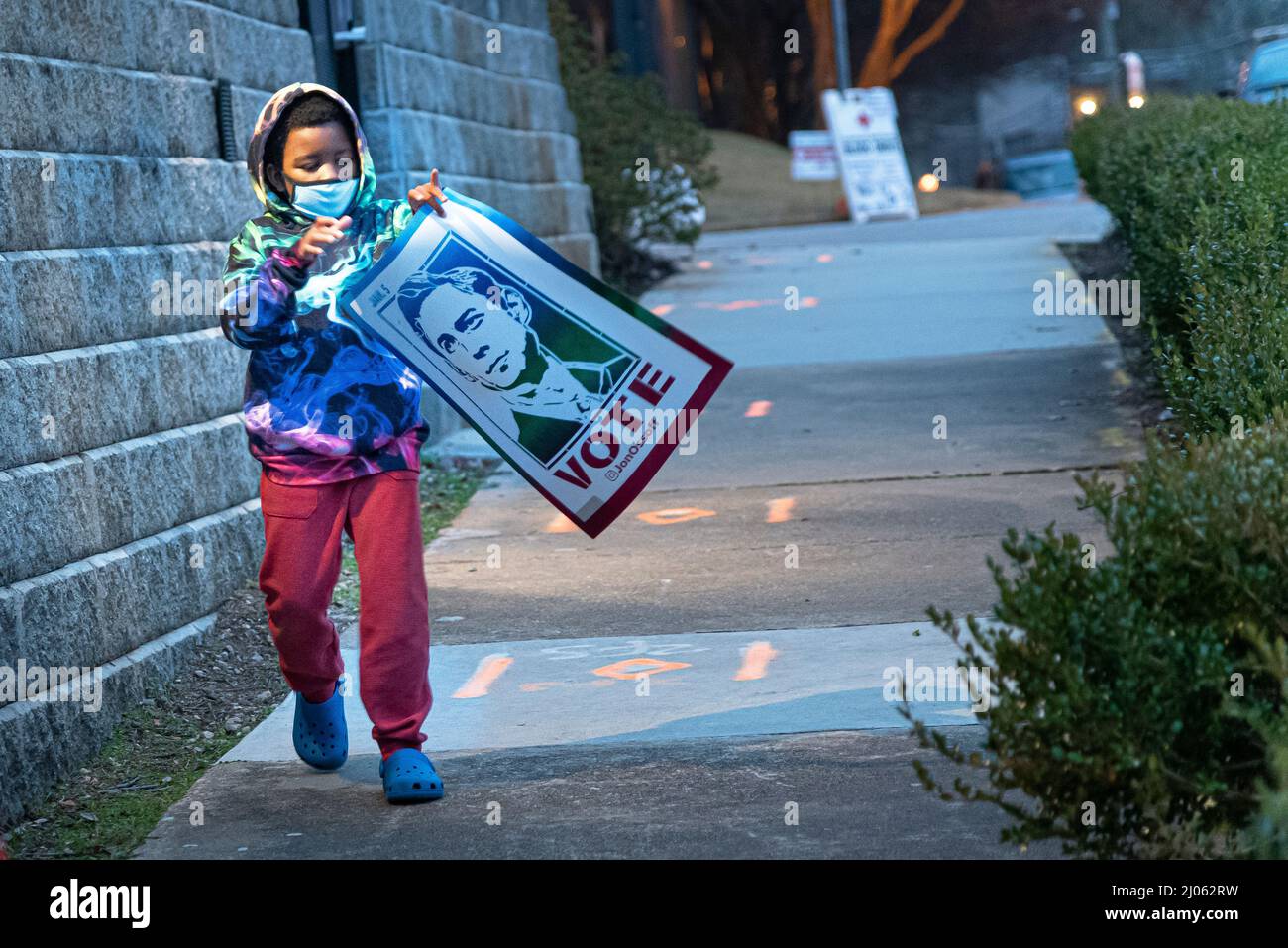 Young Boy carrying Congressman John Ossoff Banner after Campaign Rally, Atlanta, Georgia, USA Stock Photo