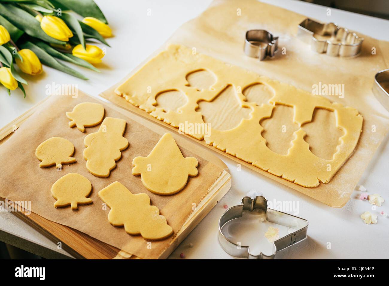 Pastry dough cut into bunny and egg shape cookies. Holidays baking. Top