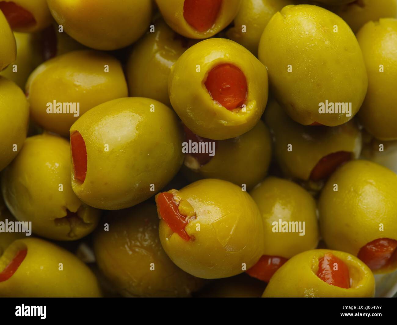 Macro shot. Lots of green stuffed olives. Healthy food, vitamins, antioxidants. Diet, vegetarian
