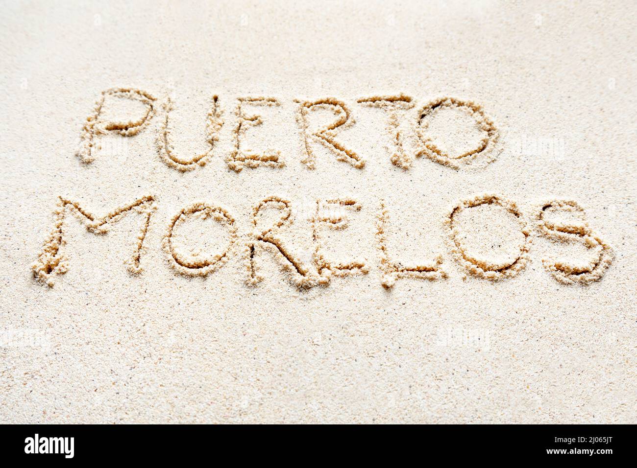 Handwriting words 'Puerto Morelos' on sand of beach Stock Photo