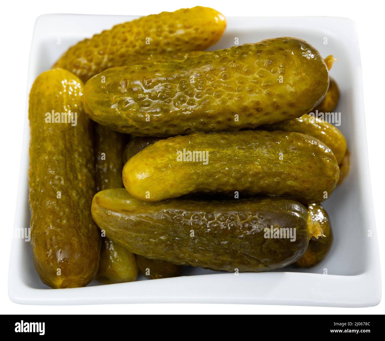 Little pickled cucumbers gherkins on plate, homemade pickles. Isolated