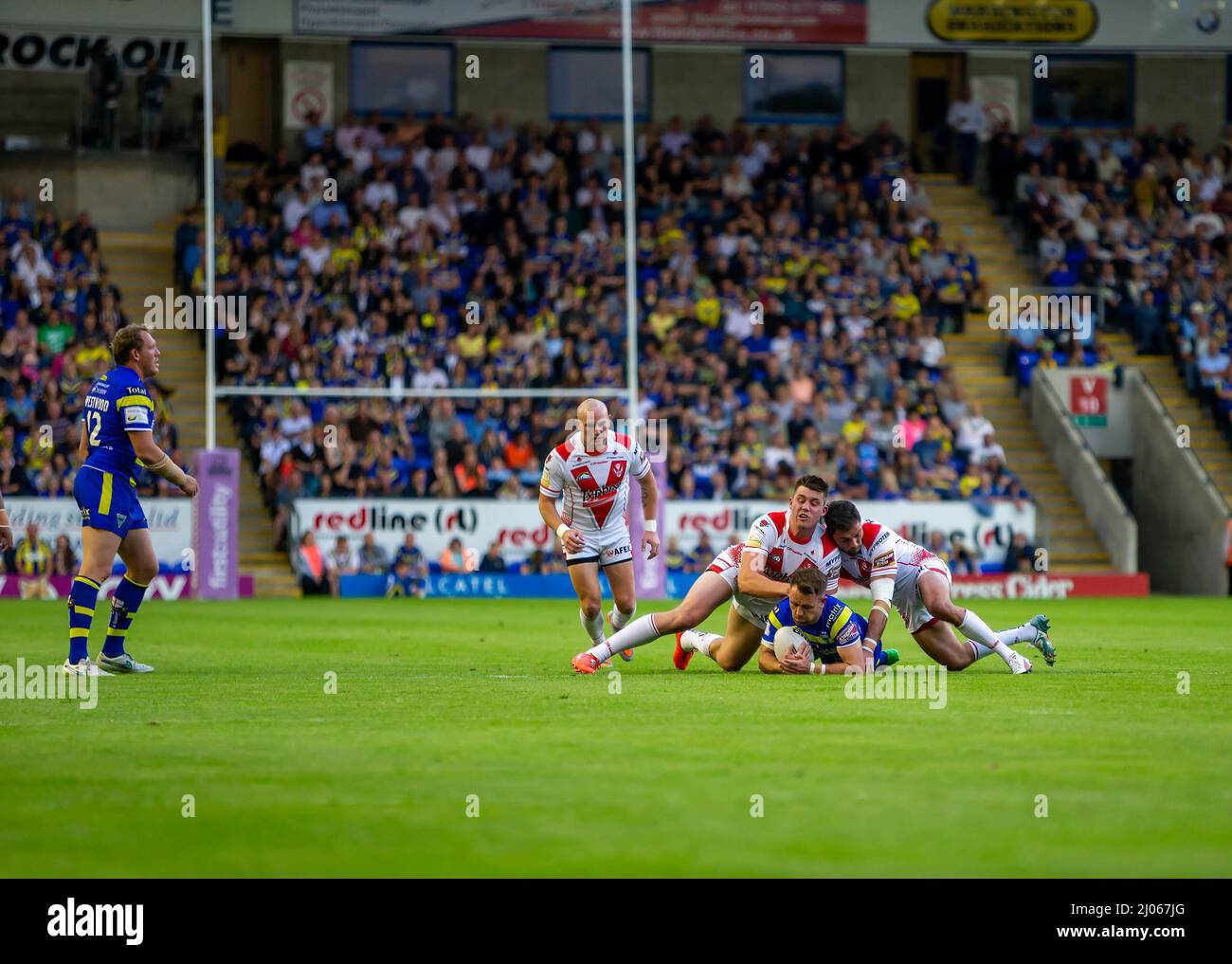 Warrington 16 July 2015: Warrington Wolves hosted St Helens at the Halliwell Jones Stadium. Richie Mtler is tackled in midfield Stock Photo