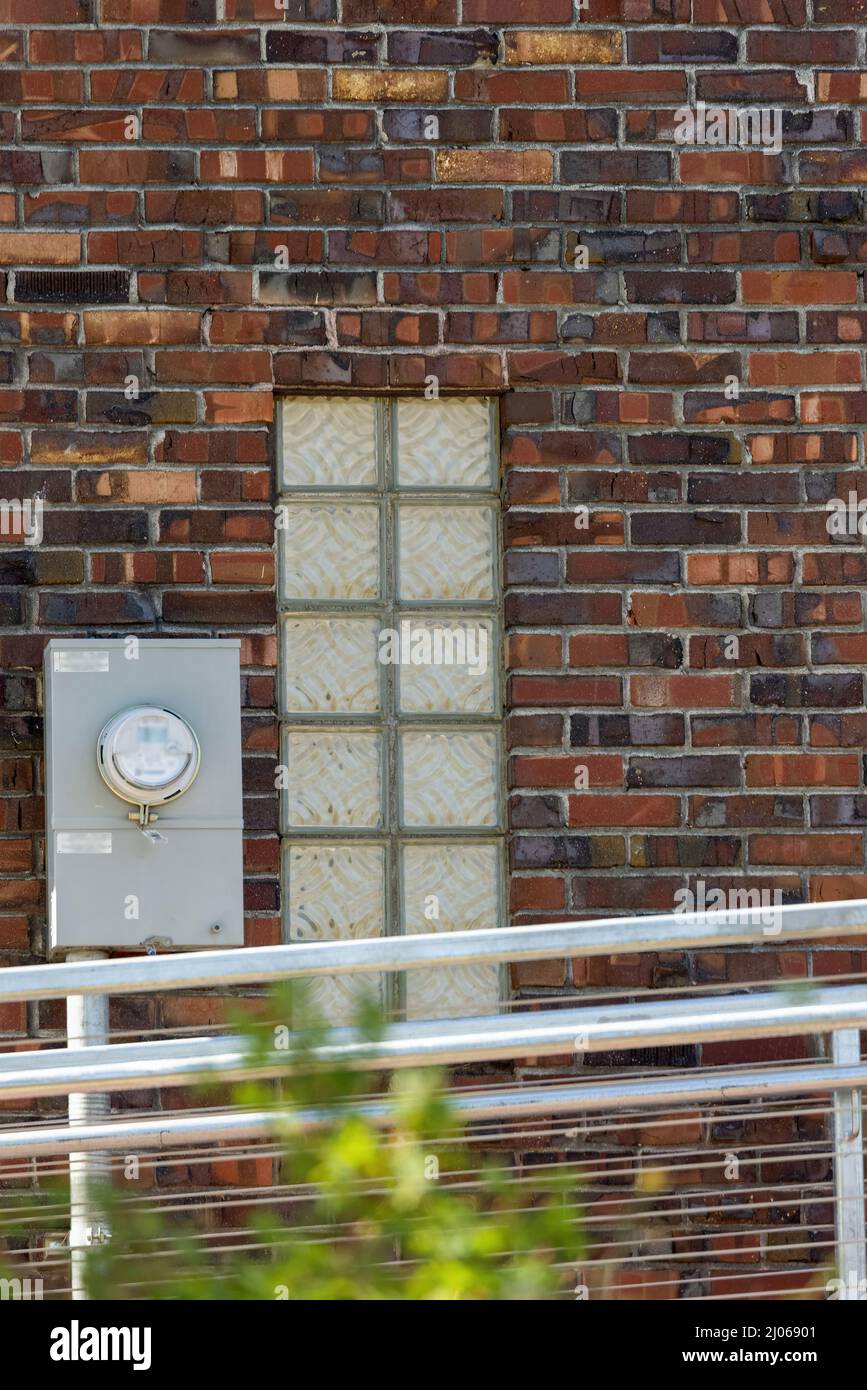 small window in old brick with modern rails Stock Photo