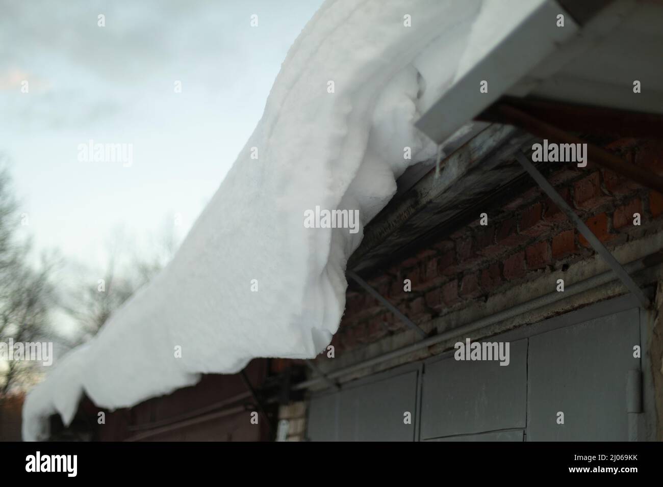 Snow on roof. Roof slope in winter. Snow weather details. Thick layer