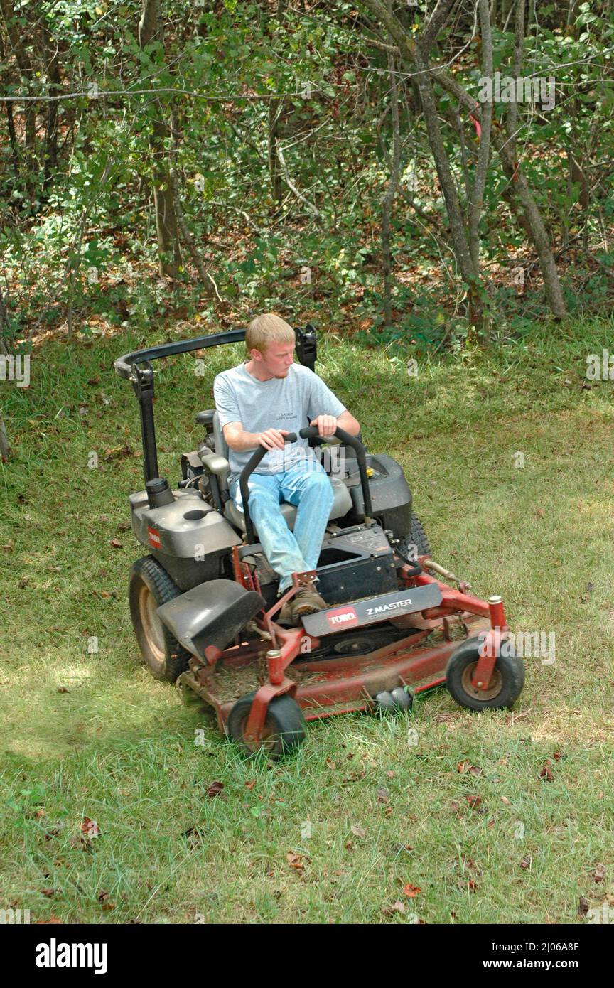 Man Cutting Yards Lawn on Ridding Mower, Southern US Stock Photo - Alamy