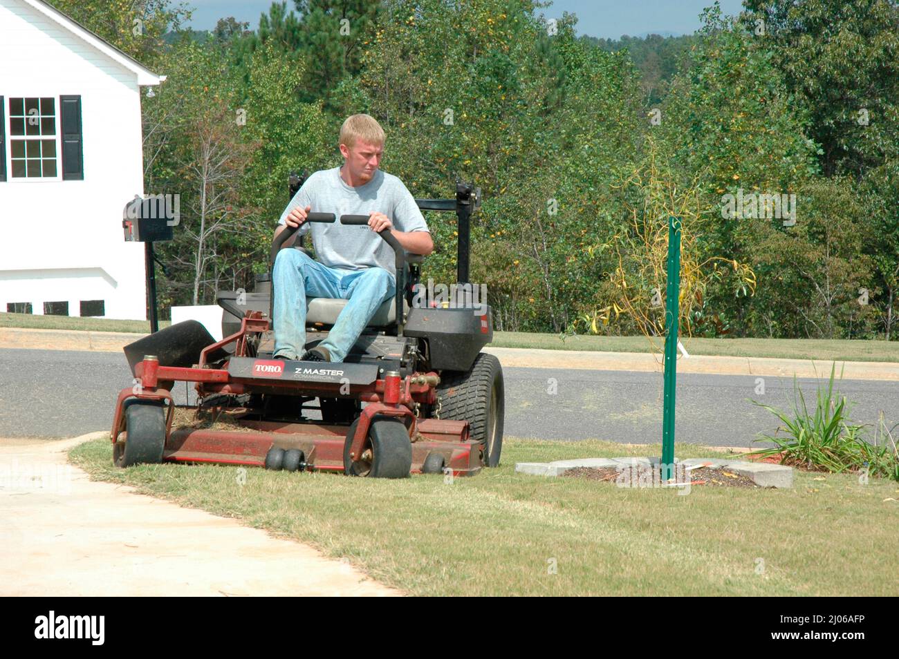 Man Cutting Yards Lawn on Ridding Mower, Southern US Stock Photo - Alamy