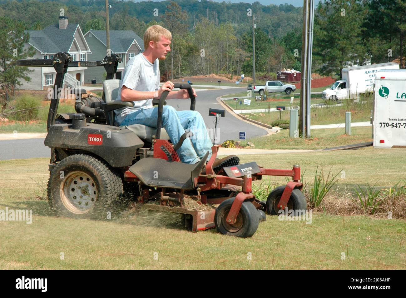 Man Cutting Yards Lawn on Ridding Mower, Southern US Stock Photo - Alamy