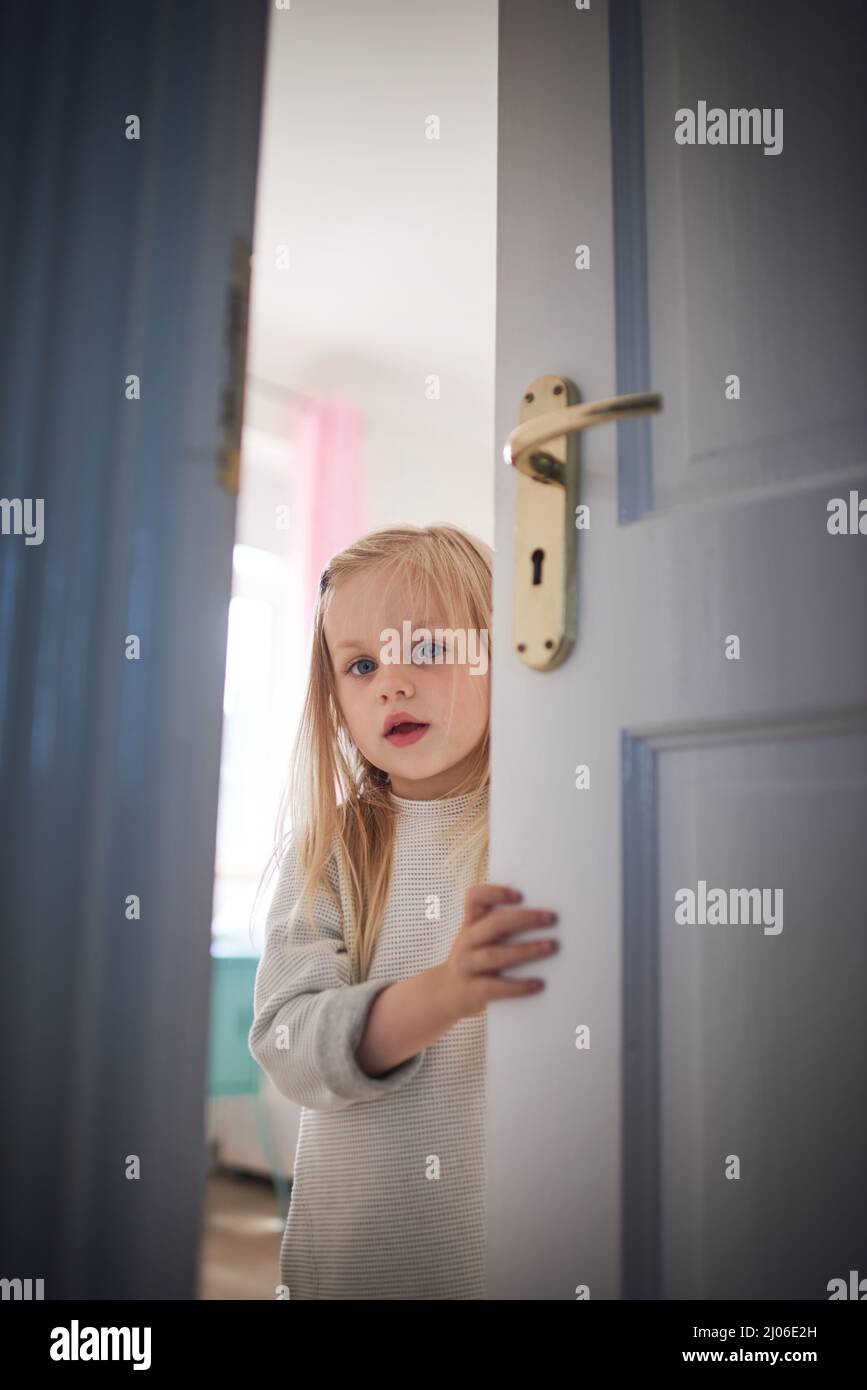 The Little Girl With A Scary Face Look At A Door Background