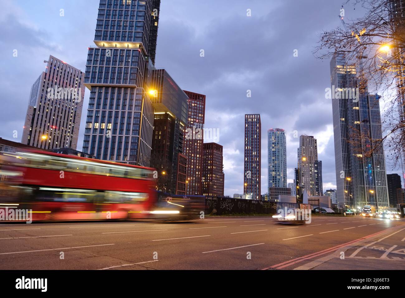 London, UK. A bus passes by at dusk in Vauxhall with new towerblocks seen in the background. Stock Photo