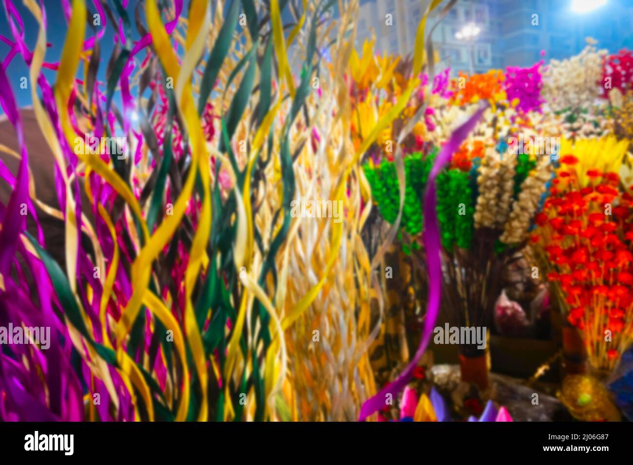 Blurred image of Cane made artificial colored flowers and plants