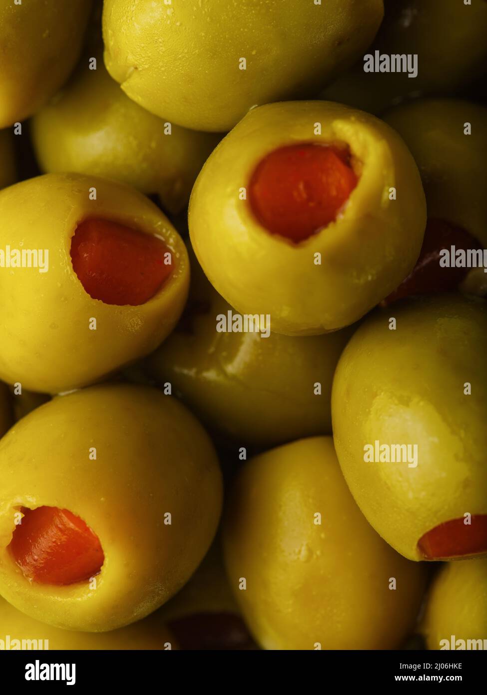 Macro shot. Green stuffed olives. Lots of objects. Cooking, snacks