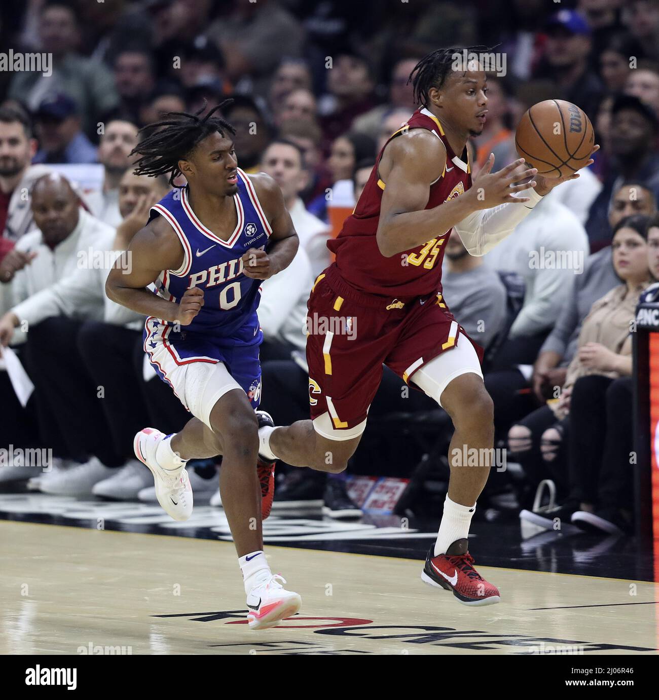 Cleveland, United States. 16th Mar, 2022. Cleveland Cavaliers Isaac Okoro (35) grabs a loose ball in front of Philadelphia 76ers Tyrese Maxey (0) at Rocket Mortgage Field House in Cleveland, Ohio on Wednesday, March 16, 2022. Photo by Aaron Josefczyk/UPI Credit: UPI/Alamy Live News Stock Photo