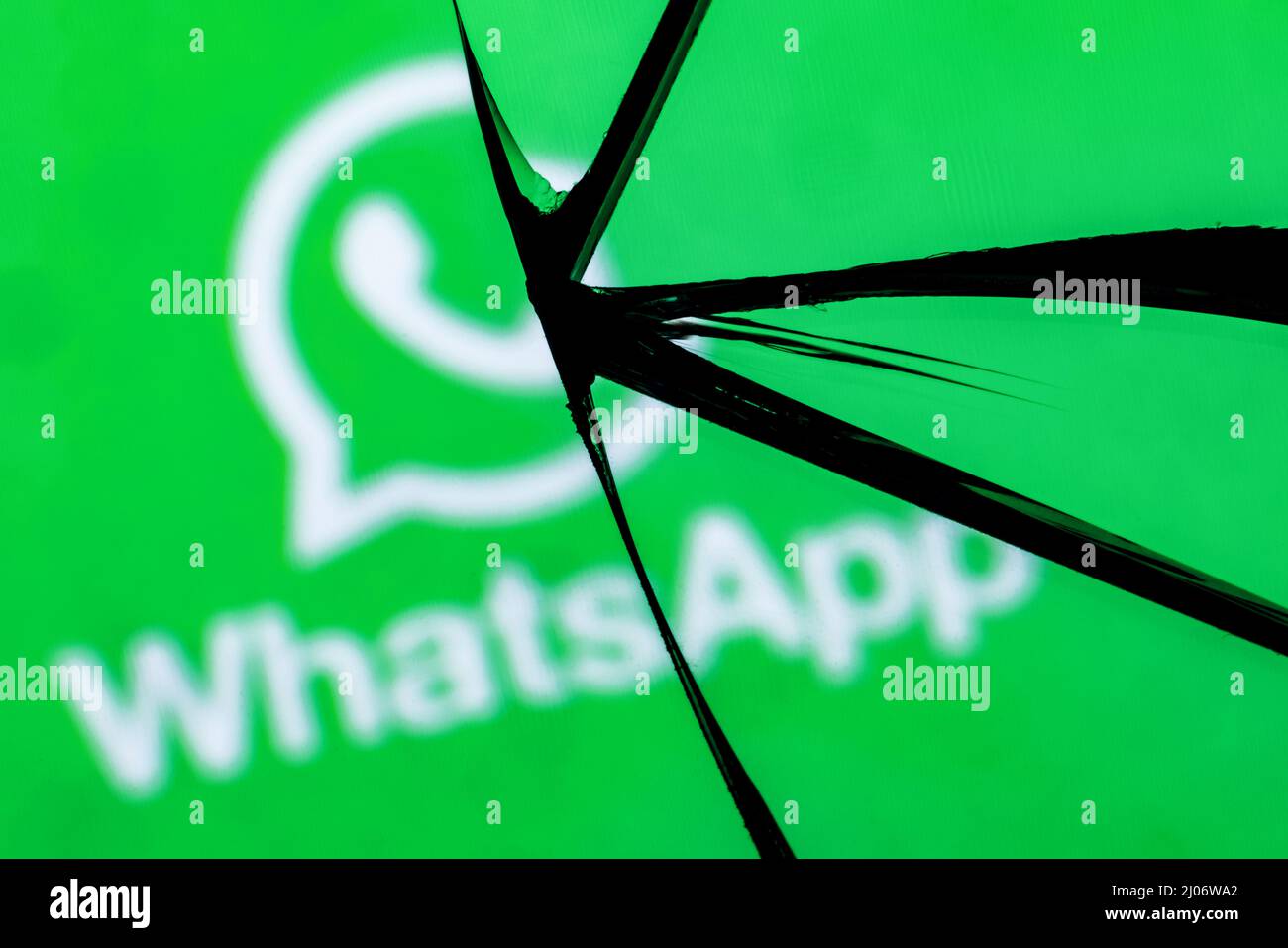 Logo of the Whatsapp messenger in the reflection of a broken mirror