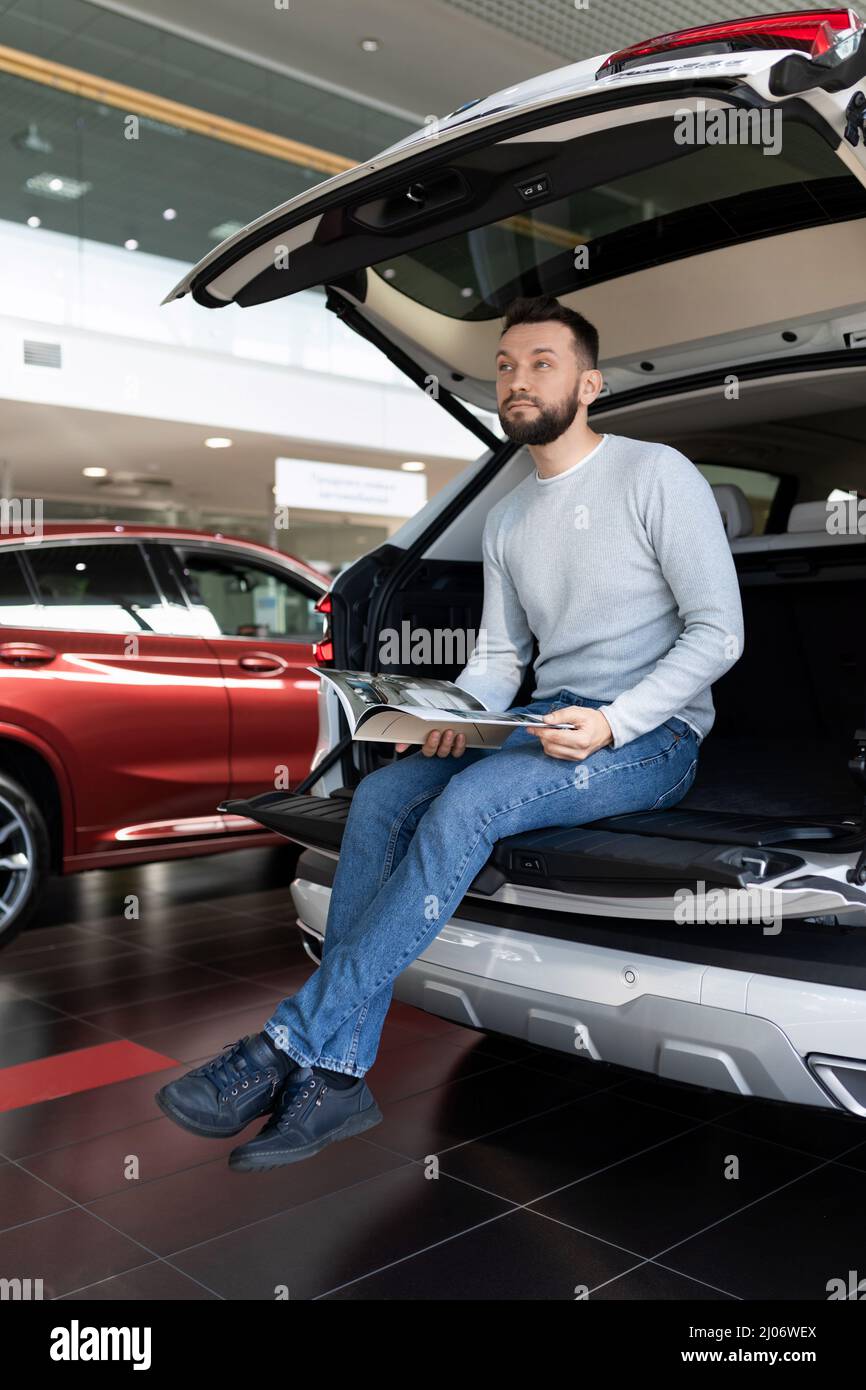 the driver in the trunk of the car chooses an insurance policy for