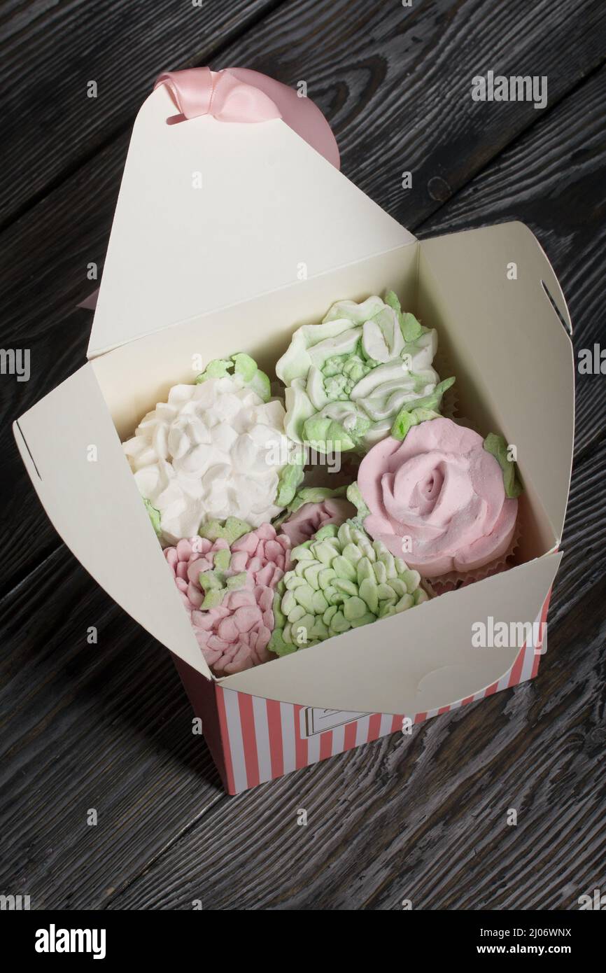 Homemade marshmallow. Marshmallow flowers. In craft boxes. On pine