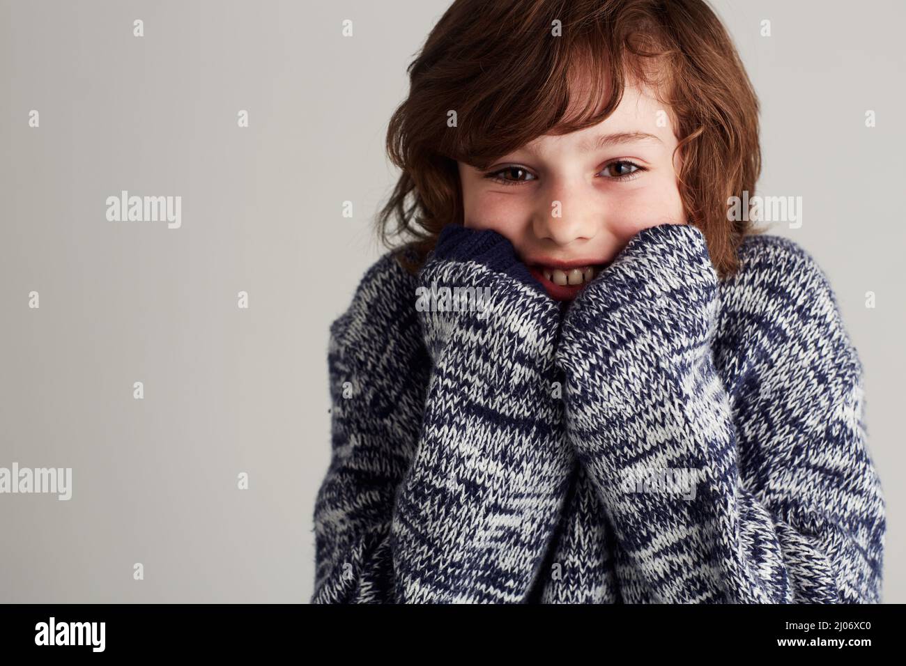 Happy and warm in my jersey. Portrait of a young boy wearing a jersey. Stock Photo