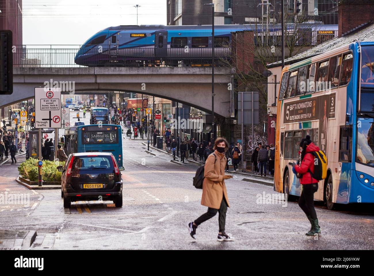 Street scene  Oxford Road Manchester, TPE train elevated track through the city centre Stock Photo