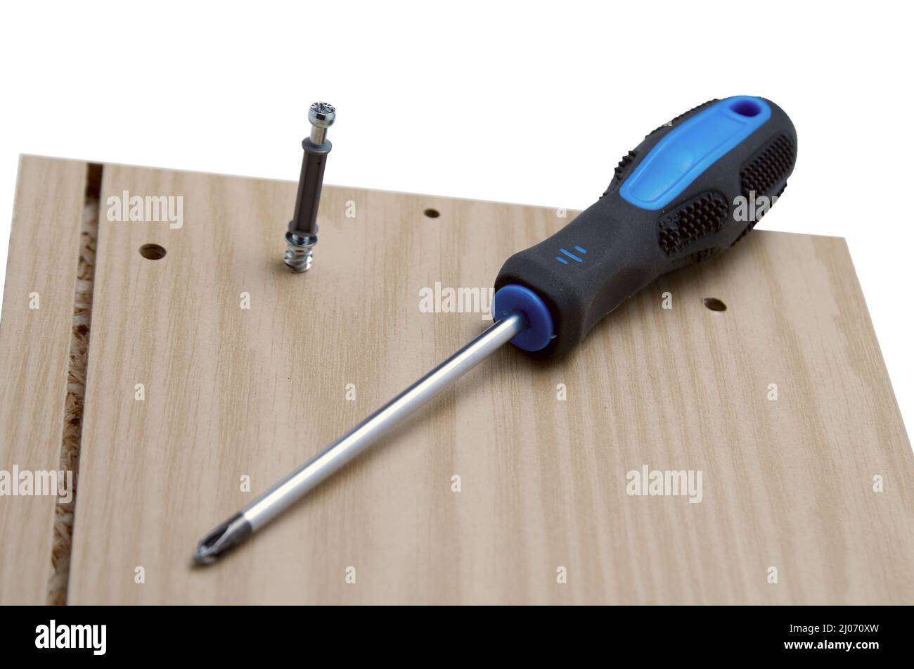 Furniture assembly screwdriver, dowel and board Stock Photo Alamy