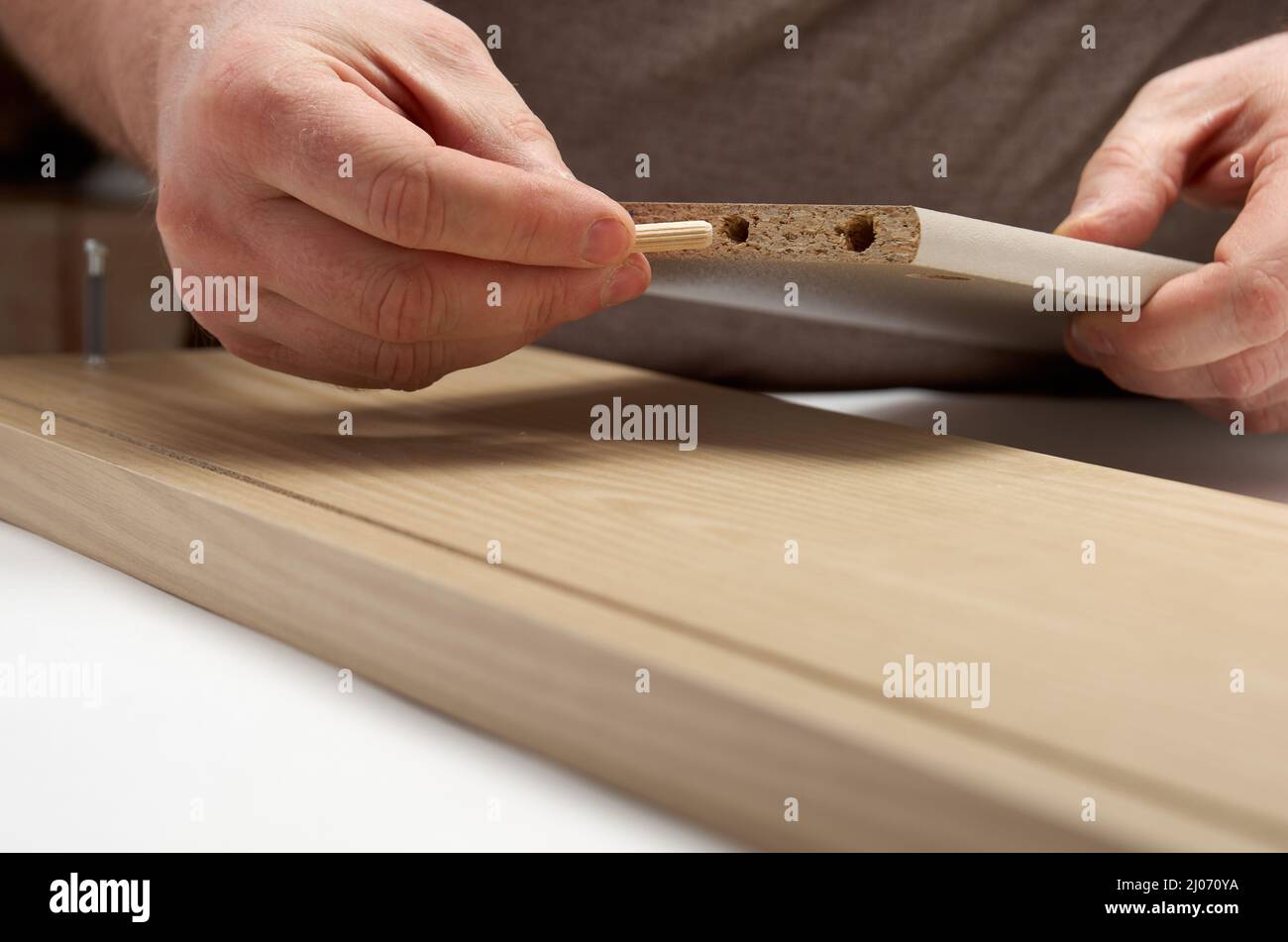 Furniture assembly installing dowel Stock Photo Alamy
