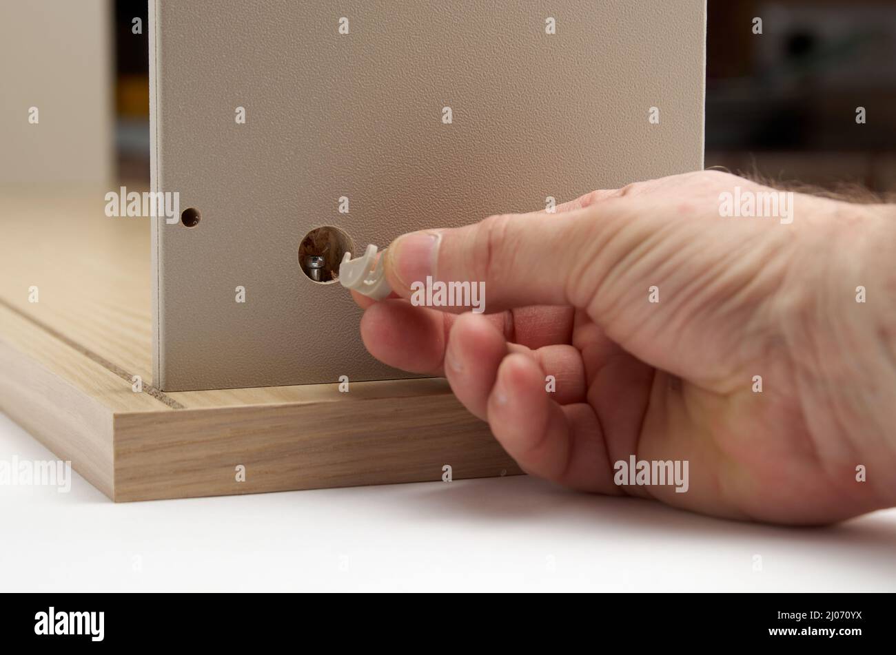Furniture assembly closing hole with dowel Stock Photo Alamy