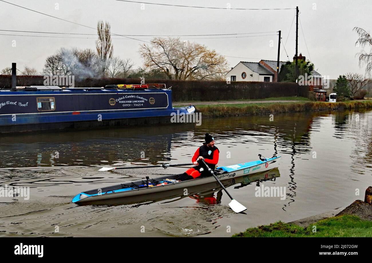 The Radio 1 DJ Jordan North rowed home on the canals to Burnley from London during the 1st week of March and here passes The Wool Boat near Burscough Stock Photo