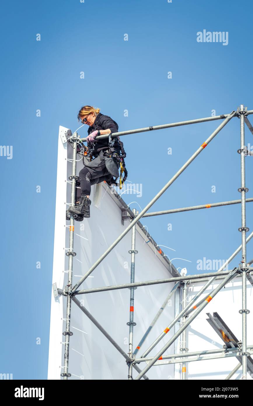 Dordrecht, Netherlands - April 15, 2019: Construction of stage for performance of The Passion. Woman scaffolder constructing scaffolding of temporary Stock Photo