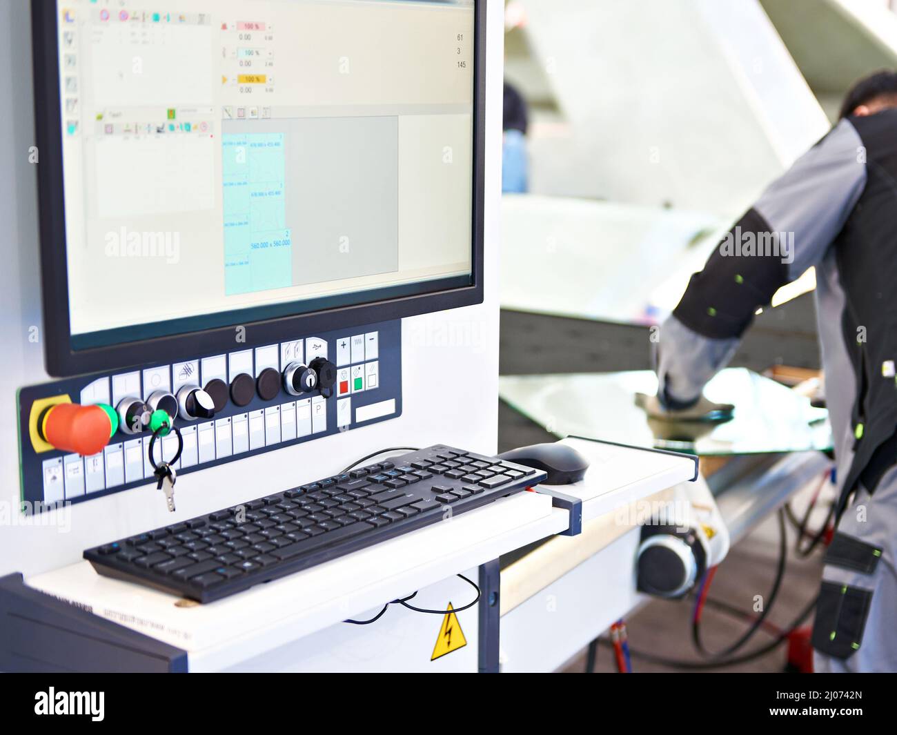 Modern glass cutting machine and worker Stock Photo